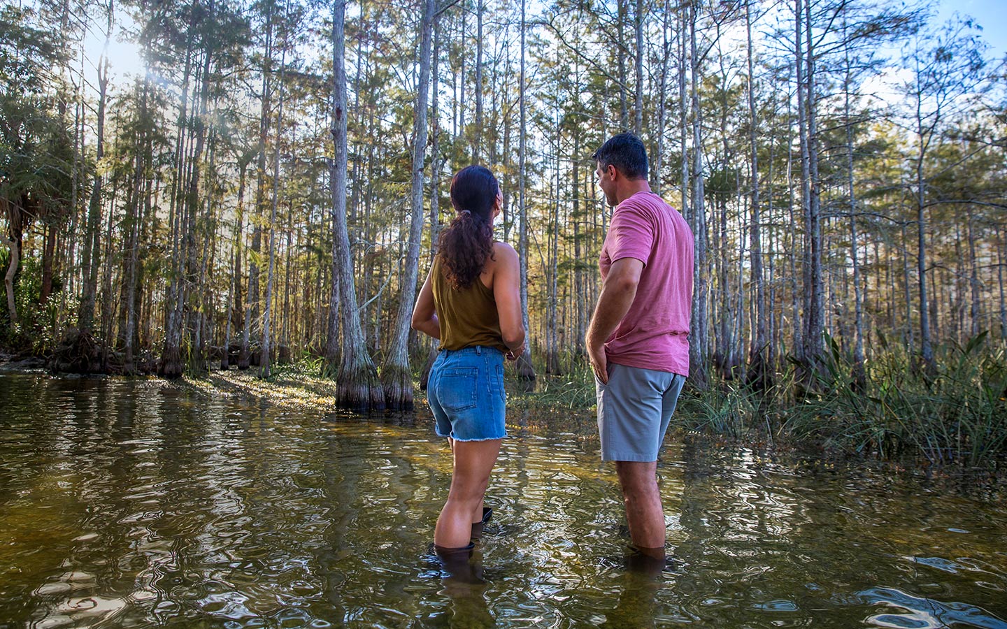 Couple on water hike at Big Cypress from back